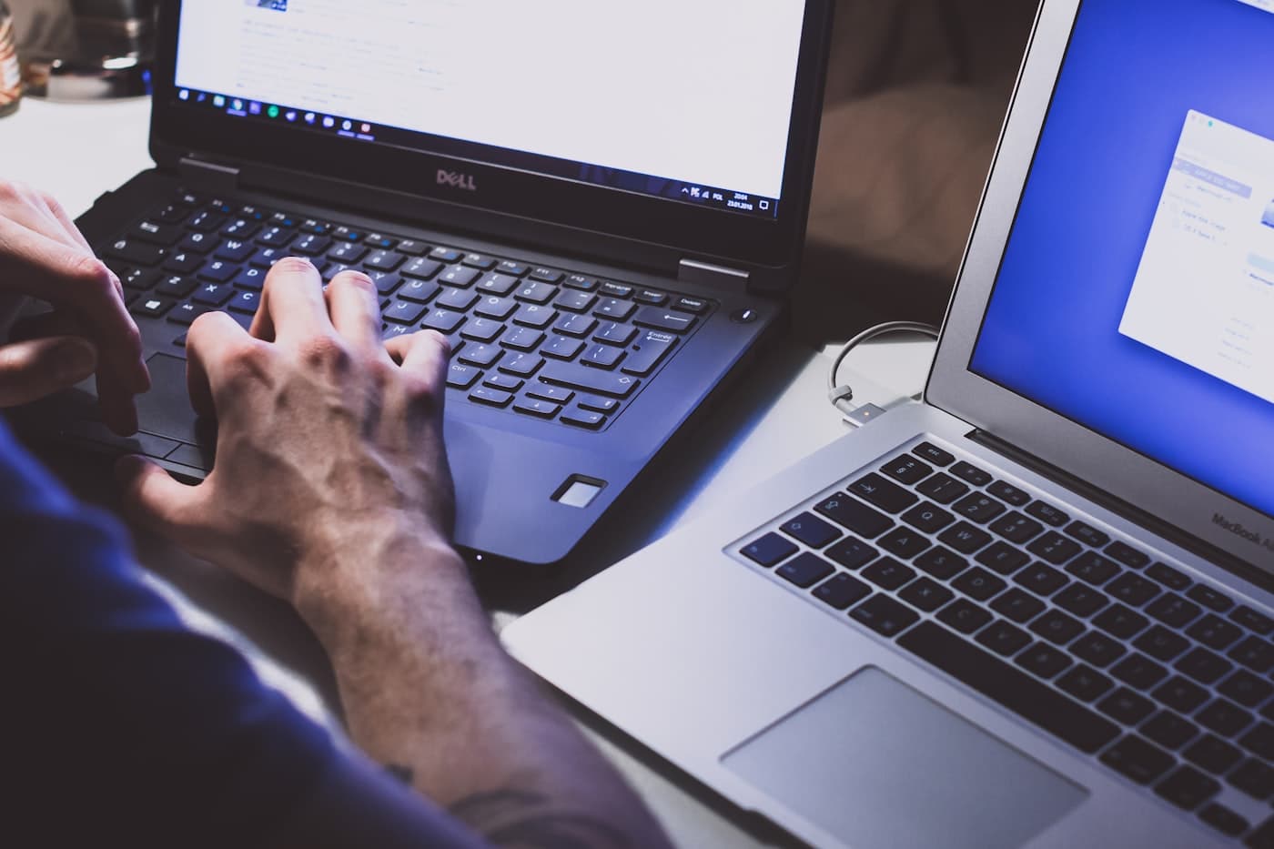 People working on laptops at a shared desk