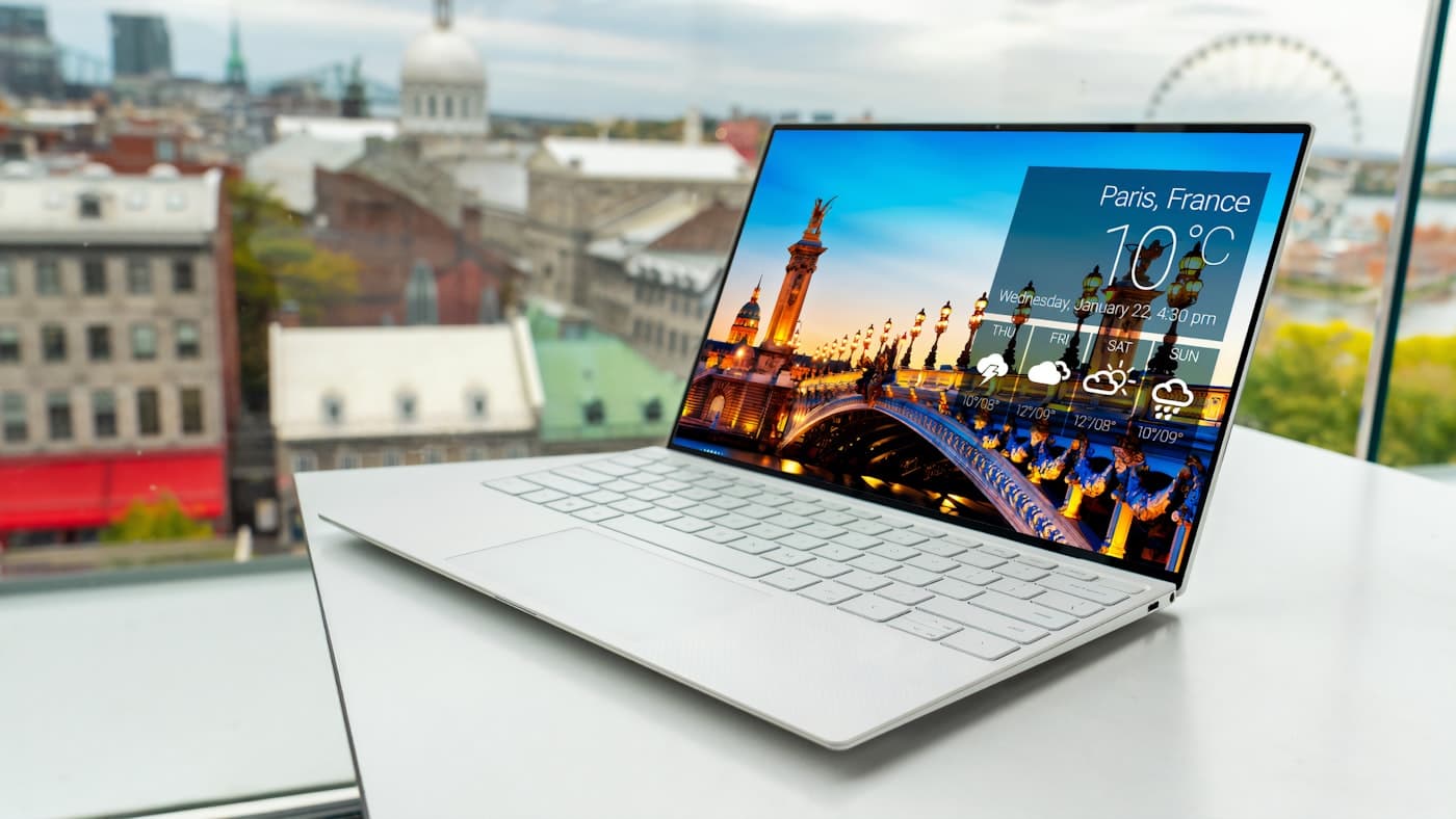Laptop open on a bright desk beside a window